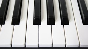 Piano keys loopable motion HD video. White and black piano keys on music keyboard seamless looping shift slow motion movement. Music background. Royal pianos full-hd video keys.