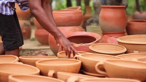 Hands counting Clay pots 