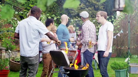 4K Happy group of friends having fun at outdoor bbq. Shot on RED Epic.