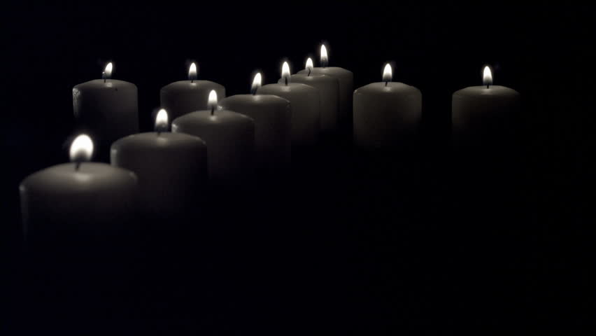 Red & White Candles in the shape of a cross against black & white backgrounds.