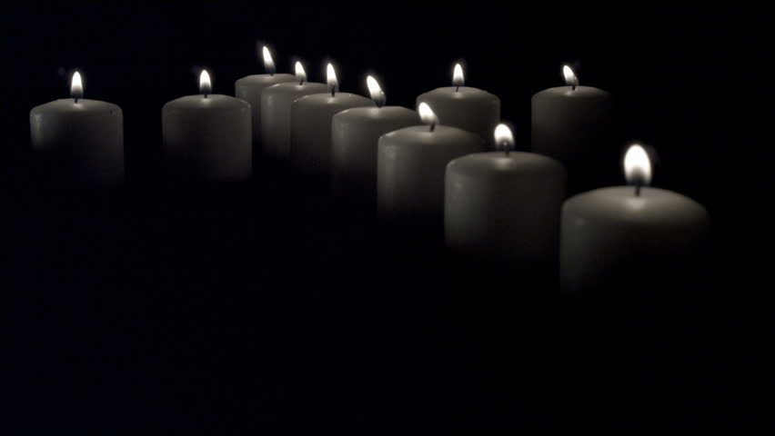 Red & White Candles in the shape of a cross against black & white backgrounds.