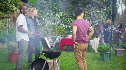 4K Happy group of friends having fun at outdoor bbq. Shot on RED Epic.