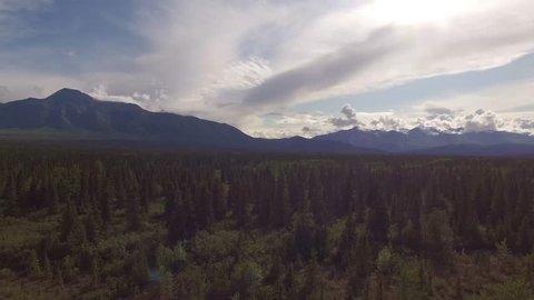 Aerial landscape in North America. Aerial road in the forest. Beautiful range mountains. Rocky Mountains in Yukon.