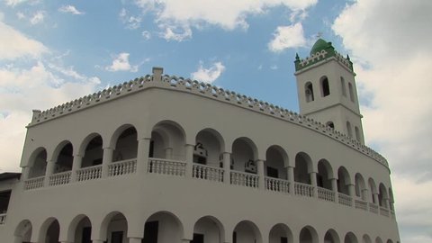 White mosque in Moroni, Grande Comore in the Comoros against a bright blue sky with white clouds