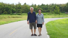  happy Asian senior couple walking exercise along the lake. Abstract love health and nature
