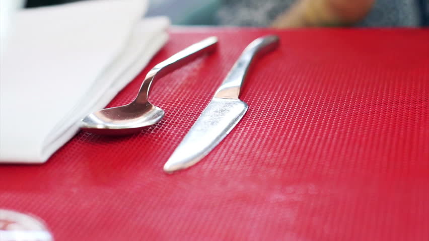 Asian woman using playing yellow case smart phone on red table