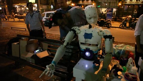 TEL AVIV, ISRAEL - SEPTEMBER 7, 2015: An intelligent robot imitates the movements of the hand of his master trainer in a street demonstration
