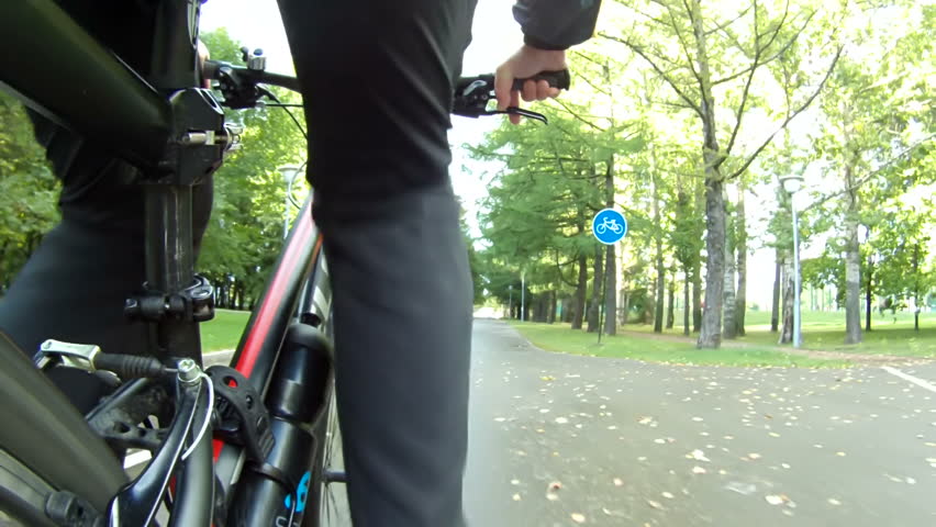 Wide Low Angle Pov Of Cyclist Bike While Riding Bicycle in sunny weather in the park Royalty-Free Stock Footage #11626568