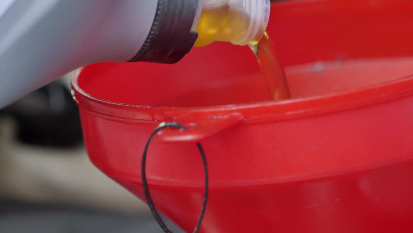 Close up of pouring engine lubrication