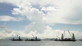 Timelapse video of cargo ship unloading containers in harbour, Hong Kong.
