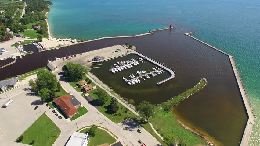 Scenic Algoma Wisconsin harbor after heavy rains. The water inside the harbor is muddy due to rain runoff from the Ahnapee River.  It’s color is strikingly different from that of Lake Michigan.