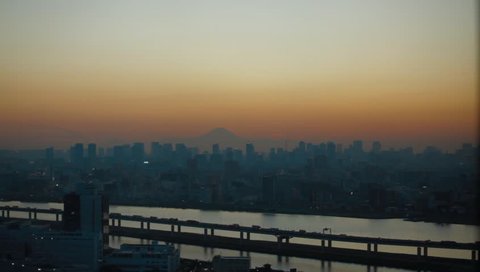 Tokyo city at twilight sunset with Mountain Fuij on the background. Flat video, No color grade.
