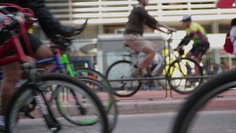 Crowds of people riding bikes in large city avenue. Green environmental movement. Commuters going to work by bicycling to work. Stockvideó