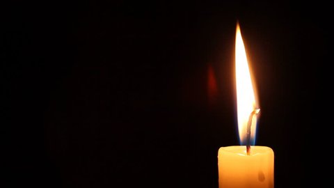 red candle burning on black background Stock Footage Video (100%