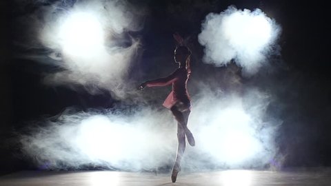 Young girl dancer jumping high in sky,   little Ballerina posing, reflection in the mirror on the background. posing ballet barre. smoke