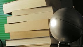 Globe map turning with a stack of books on background - Powered by Shutterstock - Get 15% off with code: PIKWIZARD15