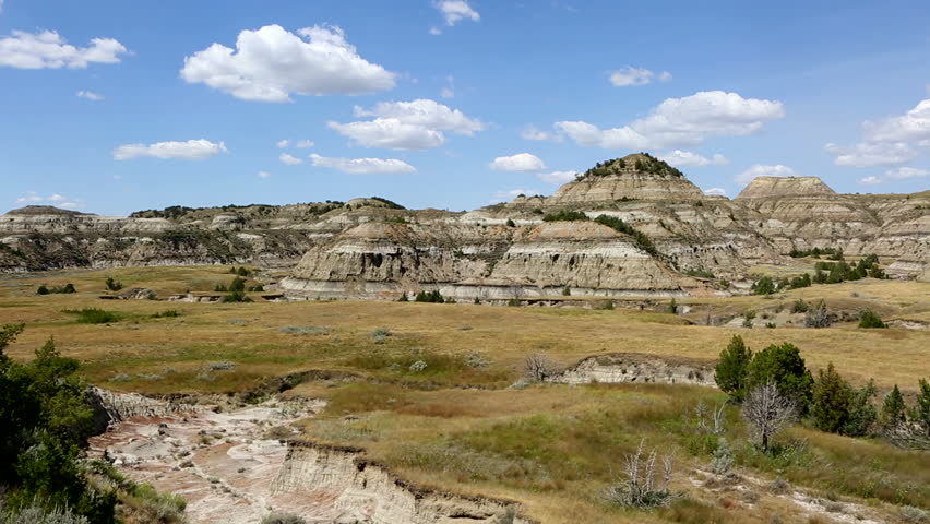 Camera pans across a view  overlooking the badlands in Theodore Roosevelt National Park in North Dakota, USA.