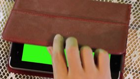 attractive hand gesture touching virtual tablet phone on green screen