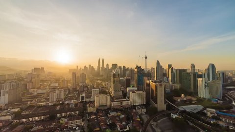 Time lapse: Kuala Lumpur skyline sunrise view during rush hour. Slide effect