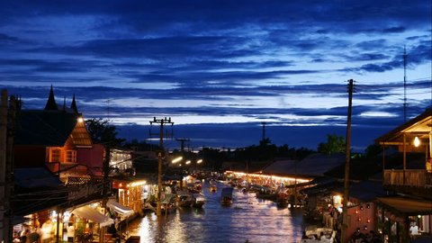 Timelapse of View of Amphawa Floating Market in Thailand. Many locals and tourists walk around the area.  It is one of the most popular floating markets in Thailand. 