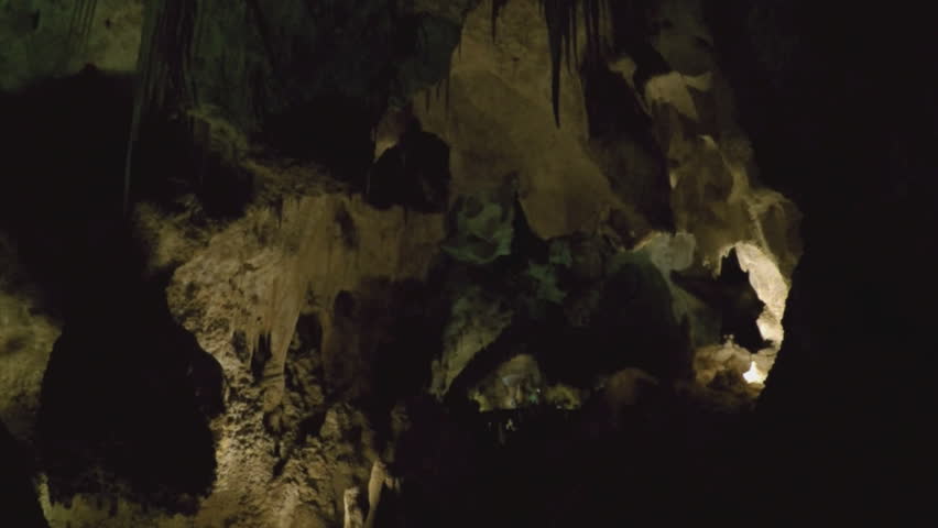Stalactites hanging from a cave ceiling in Carlsbad Caverns New Mexico. Underground rock formations grow from the movement of water and moisture over millions of years.