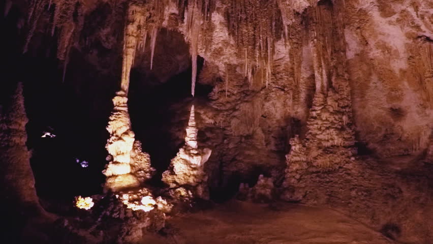 Shot of stalagmites and stalactites in an open underground room at Carlsbad Caverns New Mexico. Stalactites hanging from the ceiling have been formed over millions of years from moisture dripping in.