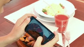 photo of food in a restaurant with mobile phone camera for social network