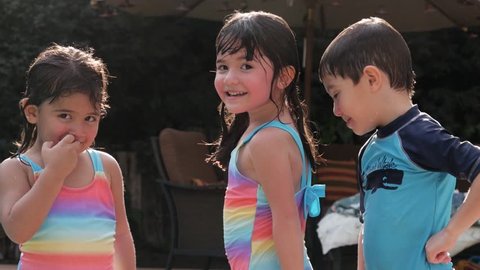 Cute Hispanic Siblings Swimsuit Portrait in Slow Motion.