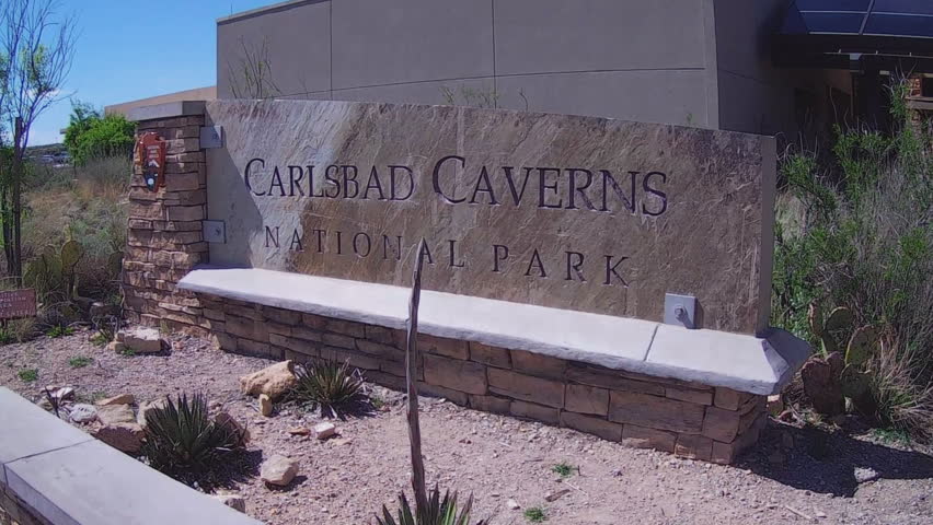 Close up shot of the Carlsbad Caverns National Park sign in New Mexico. A sign marks the location of popular tourist attraction in the Southwest.