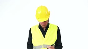 Attractive construction foreman in his 20s, wearing a yellow safety helmet with a yellow vest, holding a clipboard. White background.