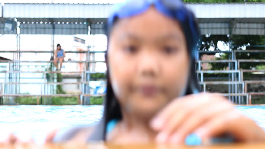 Young asian lady to playing in swimming pool