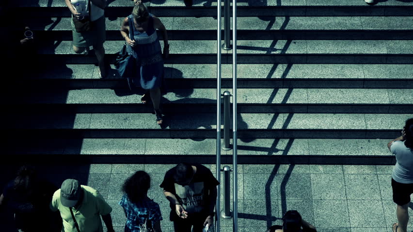 Birds eye view slow motion people walking steps to underground entrance.100-25p conformed super slow motion hd clip of an overhead view of people walking towards and away from the  train station. Royalty-Free Stock Footage #11677694