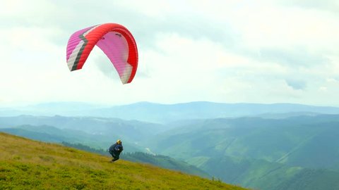 
Paraglider flying high in the mountains
