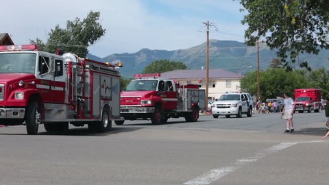 MONTICELLO, UTAH - AUG 2013: Fire trucks rural parade celebration. Small rural community parade. Local people and families having fun during annual family reunions and gathering.