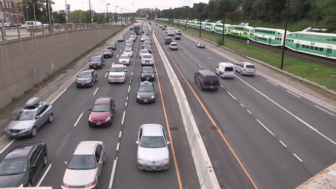 Toronto, Ontario, Canada September 2015 GO transit commuter trains and traffic stopped in Toronto traffic jam.
