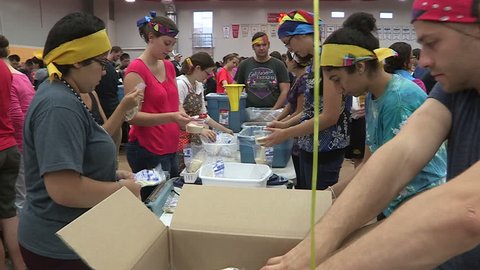 Guelph, Ontario, Canada September 2014 Volunteers package charity food aid for homeless and starving in Africa
