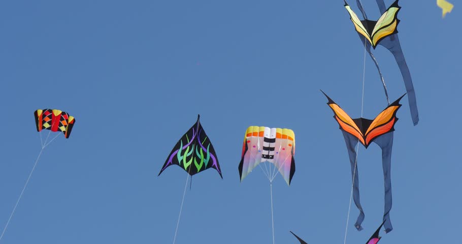 Dozens of kites are soaring in the sky during the International kite festival in Leba, Poland. People are flying the kites in the sand of the beach on the Baltic sea shore. Royalty-Free Stock Footage #11687336