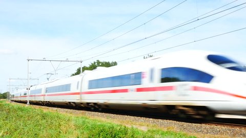 ZEVENAAR, THE NETHERLANDS - SEPTEMBER 10, 2015: ICE High Speed Train driving past in the country during a beautiful summer day.