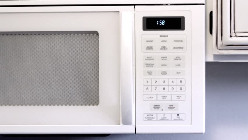 A man turns on the microwave