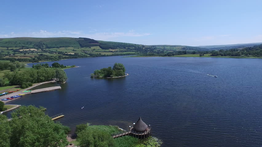 Aerial view of Wales in Great Britain. Shot from helicopter towards natural mountain ranges, rivers and lakes.