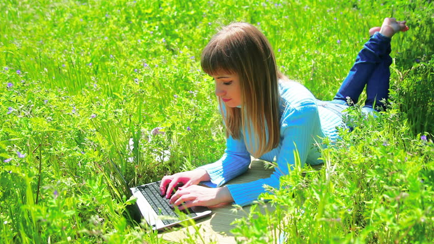 Lady on the field and works at laptop. Dolly work profile.
