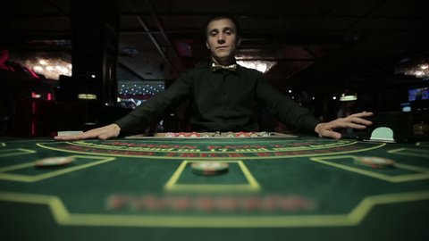 Dealer plays blackjack in casino