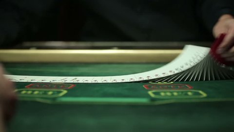 Casino: Dealer shuffles the poker cards. Slow motion
