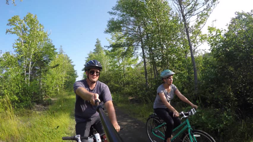 A family riding bikes on a beautiful biking trail in Cape Breton Nova Scotia