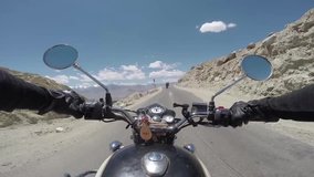 Driver riding on motorcycle on scenic high mountain winding road following friends on motorbikes - Powered by Shutterstock - Get 15% off with code: PIKWIZARD15