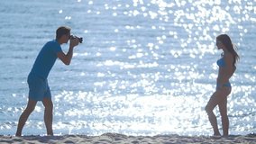 4 in 1 video! The photographer (cameraman) shoot the woman (model) on the beach by sunlight reflection on the water surface background.