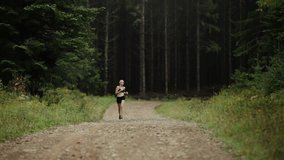 Woman Running Lonely on a Gravel Road in Forest