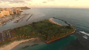 Sunset aerial over Honolulu, at Ala Moana Beach and Magic Island Beach Park towards Waikiki and Diamond Head