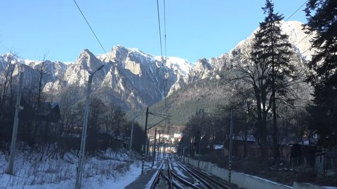 BRASOV - ROMANIA, CIRCA FEBRUARY, 2015, 4K POV Point of view of train pass in mountain railway by day