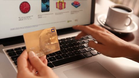 Online shopping. 3 shots. Dolly. Female hand holding a gold credit card and shopping online. More options in my portfolio.